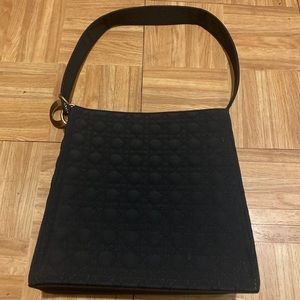 black handbag with rings on strap